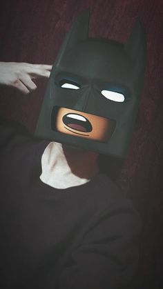 a man wearing a batman mask with glowing eyes