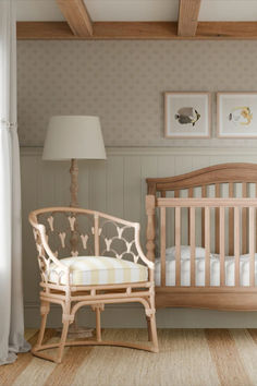 a baby's room with a crib, rocking chair and pictures on the wall