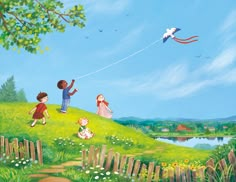 children flying kites on a grassy hill above a lake and fenced in area