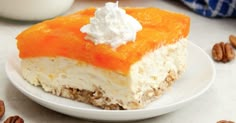 a piece of cake on a plate with whipped cream and oranges in the background