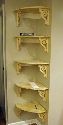 three wooden shelves in the corner of a room