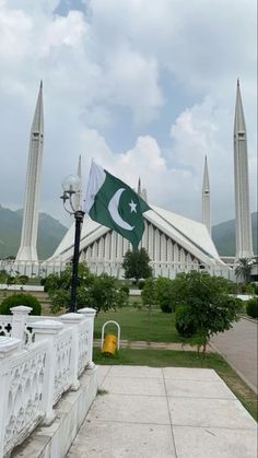 a flag flying in front of a large building