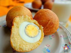 two rolls with an egg inside on a plate