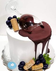 a cake decorated with wine, grapes and corks