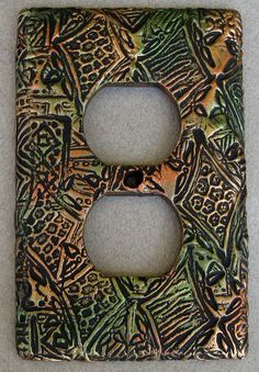 a decorative light switch plate cover is shown