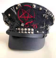 Gothic Punk Military hat with pentagram Badges and cross with studs all round the front  This is a black leather look Military style hat with front metal studs Please refer to photos. Available in size 56,57,58,59cm Please note:- Even though there is a choice of sizes, these are made to order and are customise to your requirements . I do not carry stock and hence do not do refunds. Please check the sizes before you commit to your purchase. Thank you Thank you for looking. Goth Punk Accessories, Patches For Clothes, Outfit Ideas Punk, Punk Style Adjustable Brimmed Hat, Punk Hats, Punk Style Hat For Streetwear, One Size Fits Most, Steam Punk Fashion, Punk Hat, Punk Clothes