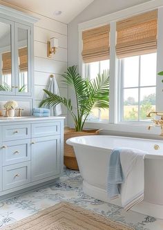 a bathroom with a tub, sink and large mirror in it's center area