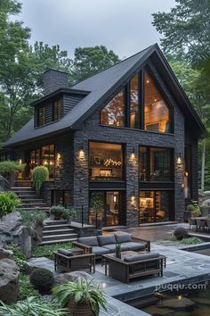 a house that is surrounded by trees and rocks