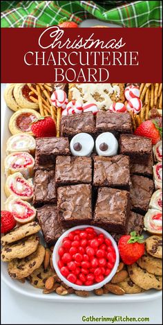 a christmas charcuterie board with chocolate brownies, raspberries and pretzels