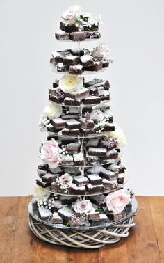 a tower of pastries with flowers on top