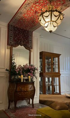 an ornately decorated room with a chandelier hanging from it's ceiling