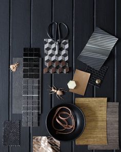 a table topped with lots of different items on top of a wooden floor covered in black and white tiles