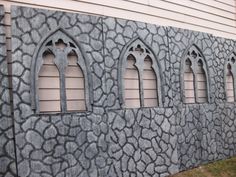 a building made out of rocks with arched windows