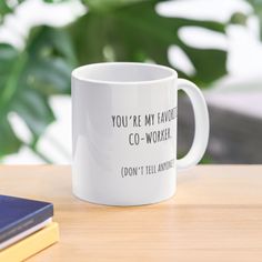 a coffee mug that says you're my favorite co - worker don't tell anyone