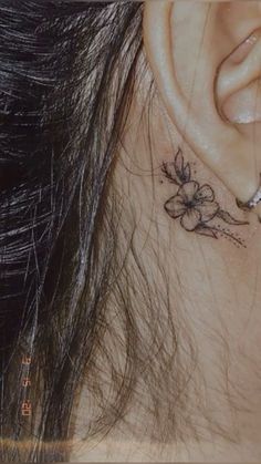 a close up of a person's ear with flowers on it