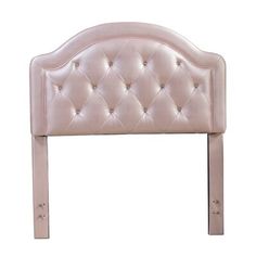 an upholstered headboard with metal legs and buttons on the top, against a white background