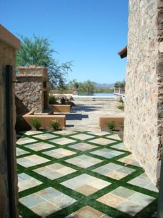 an open door leading to a patio with grass on the ground