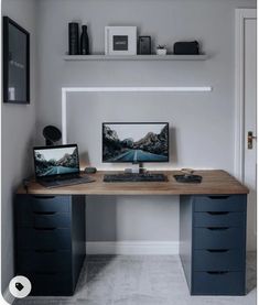 a computer desk with two monitors on it