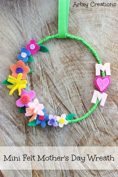 a craft made with felt flowers and the words mom's day wreath