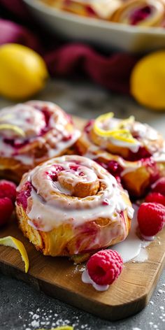 raspberry lemon rolls with icing on a cutting board