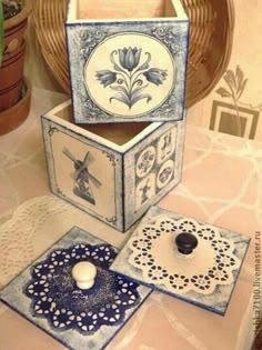 three decorative boxes sitting on top of a table