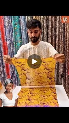 a man standing in front of a table covered in fabric