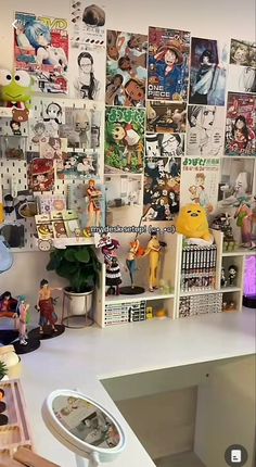 a white desk topped with lots of pictures and figurines