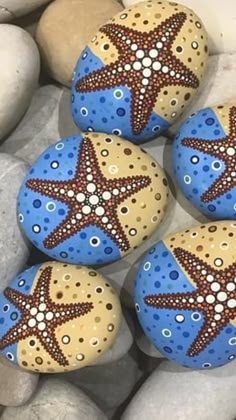 four painted rocks with starfish designs on them