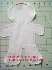 a paper cut out of a person on top of a cutting mat