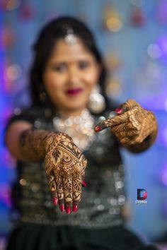 a woman with henna on her hands