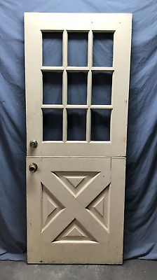 an old white door with glass panels on it