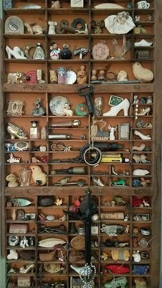 an old wooden shelf filled with lots of figurines and knick - knacks