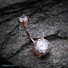 two diamond rings sitting on top of a rock