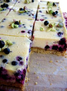 blueberry and pistachio cheesecake cut into squares