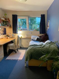 a bed room with a neatly made bed and a desk