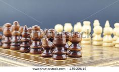 a chess board with pieces on it and one piece in the middle, ready to be played