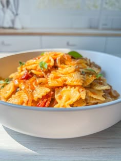 a white bowl filled with pasta and sauce