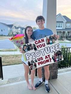 a man and woman holding up a sign that says can you picture us at prom?