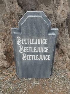 a grave with the words beetlejuice, beetlejuice and beetlejuice written on it