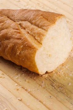 a loaf of bread sitting on top of a wooden cutting board