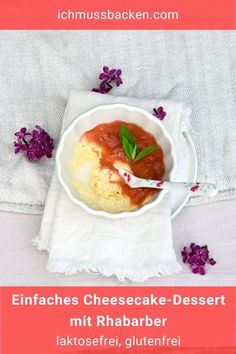 a bowl of cheesecake dessert with raspberry sauce