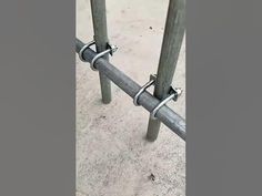 two metal poles are connected to each other on the concrete ground near a fire hydrant