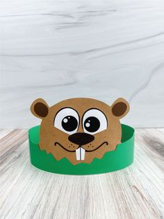 a paper animal head sitting on top of a green bowl