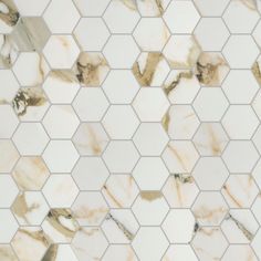 a white and brown marble tile with hexagonal design on it's sides