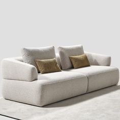 a white couch sitting on top of a carpet covered floor