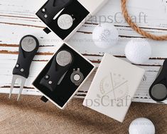 three golf tees and two ball markers in boxes