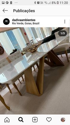 the table is made out of glass and has an interesting wooden design on it's legs