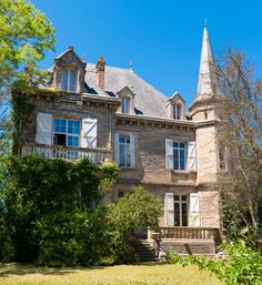 an old stone house with a steeple on top