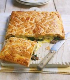 a close up of a pie on a cutting board