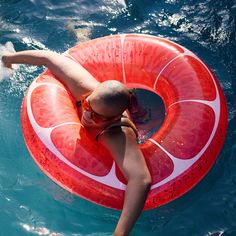 a woman floating on top of an inflatable tube